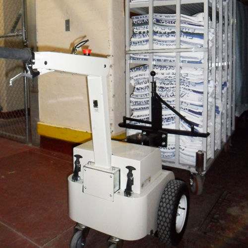 Tug Compact Linen Mover hitched to a linen trolley
